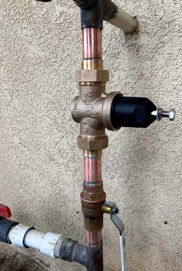 New brass water pressure reducing valve installed on copper plumbing by Hydro Plumbing