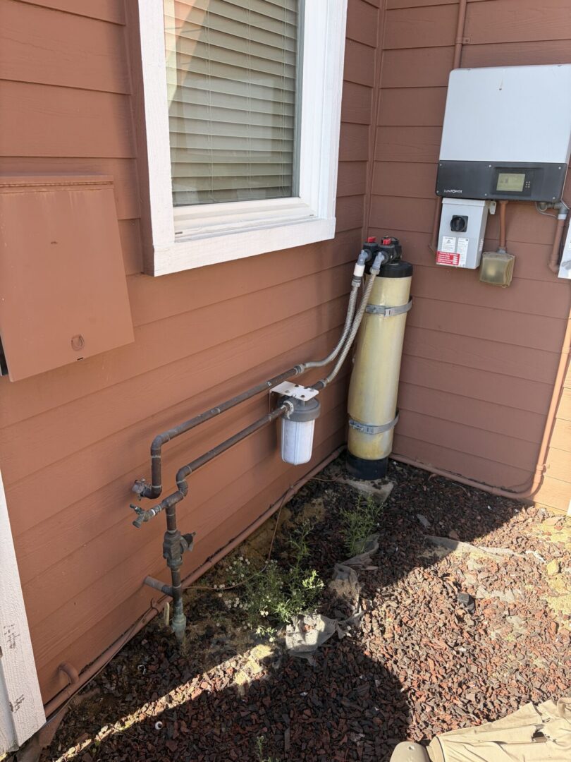 Older whole-house water filter before replacement in Temecula California