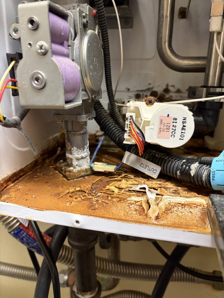 Hard water mineral buildup and corrosion inside a Navien tankless water heater serviced by Hydro Plumbing in Murrieta, California.