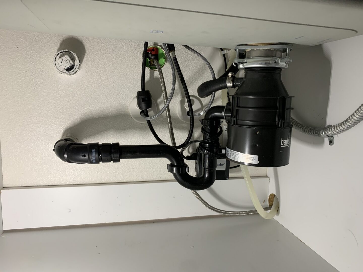 Finished kitchen sink drain and under-sink plumbing connections installed by Hydro Plumbing